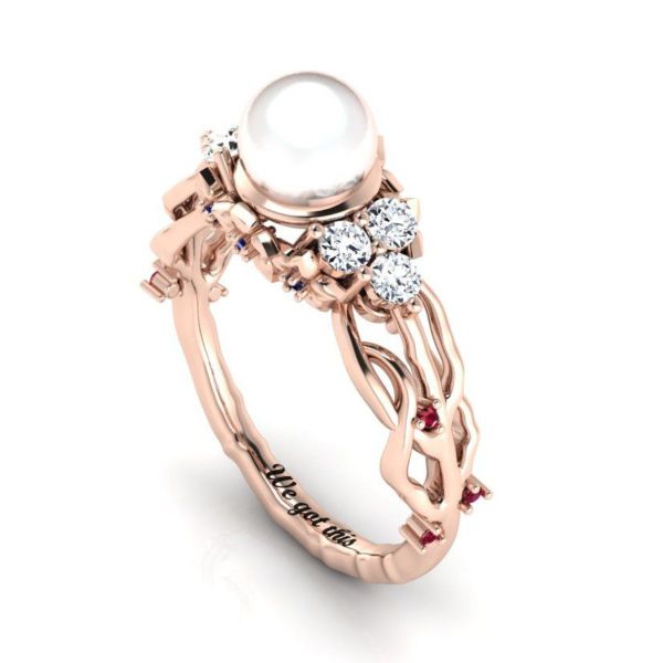 The pearl at the center of this autumn-inspired ring glows against the rose gold band as well as the ruby and sapphire accents.