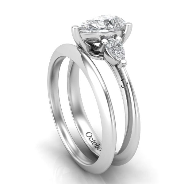 This beautiful pear cut moissanite centerpiece features matching accents and anchor engravings along the platinum band.