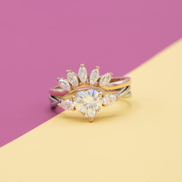 A tiara of marquise moissanites make up the wedding band to match the heart shaped moissanite engagement ring.