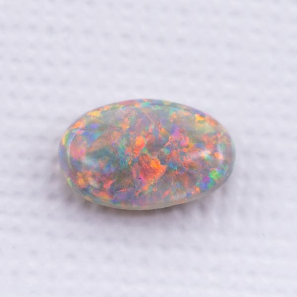Light opal with an incredible mix of colors (reds, oranges, violets, blues, and greens).