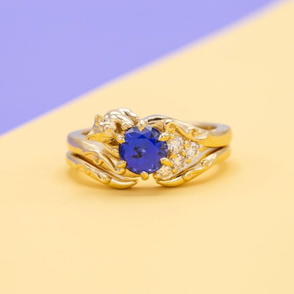 A lab created sapphire is caught by a playful cat in this engagement ring.