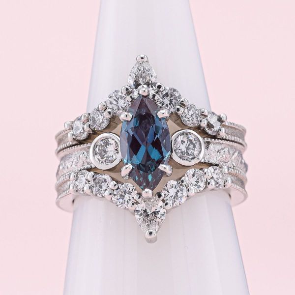 This engagement ring features a lab alexandrite in white gold with diamond accents.