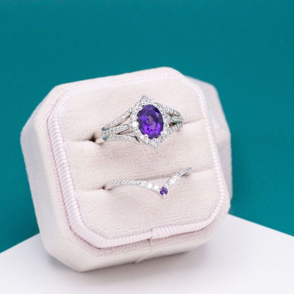 White gold holds an amethyst center stone and diamond accents.
