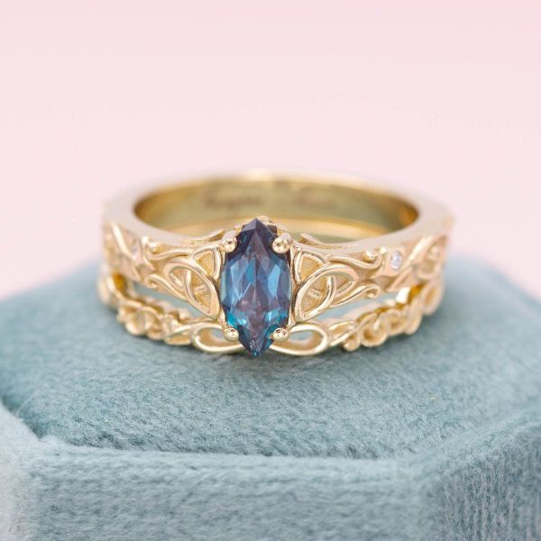 This ethereal yellow gold engagement ring holds a marquise cut alexandrite in its center.
