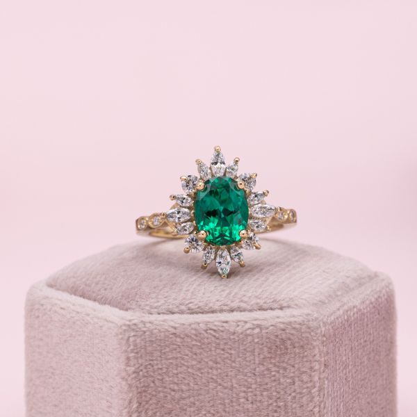 The emerald at the center of this antique inspired engagement ring is 2.5 carats.