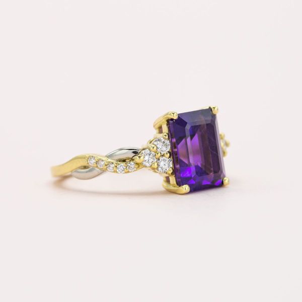 This emerald cut amethyst is pure artistry in the mixed metal engagement ring.