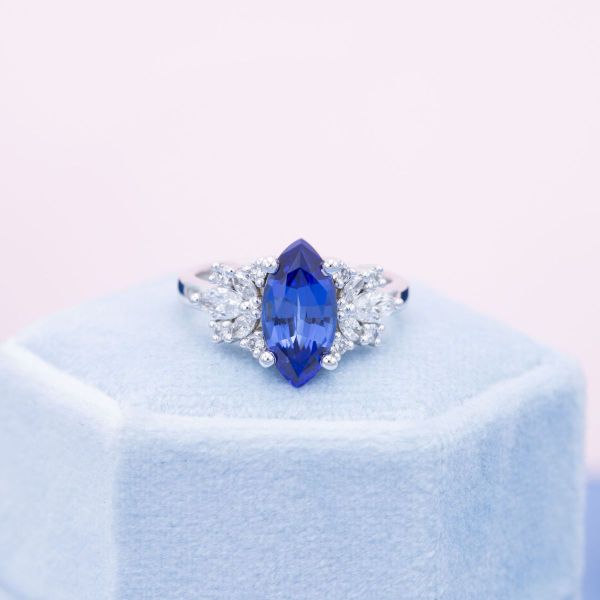 A blue, marquise cut sapphire engagement ring featuring a white gold band.