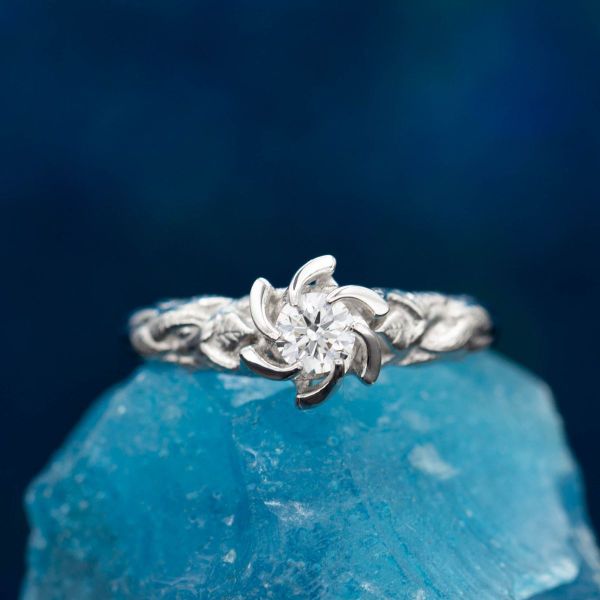 The diamond takes the stage as petals part to the side in this Nenya inspired ring that looks like a rose.