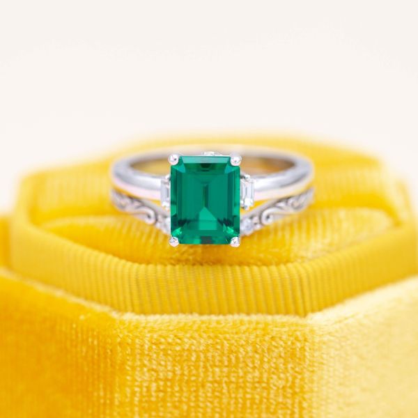White gold brings out the cool tones of this emerald cut emerald engagement ring.