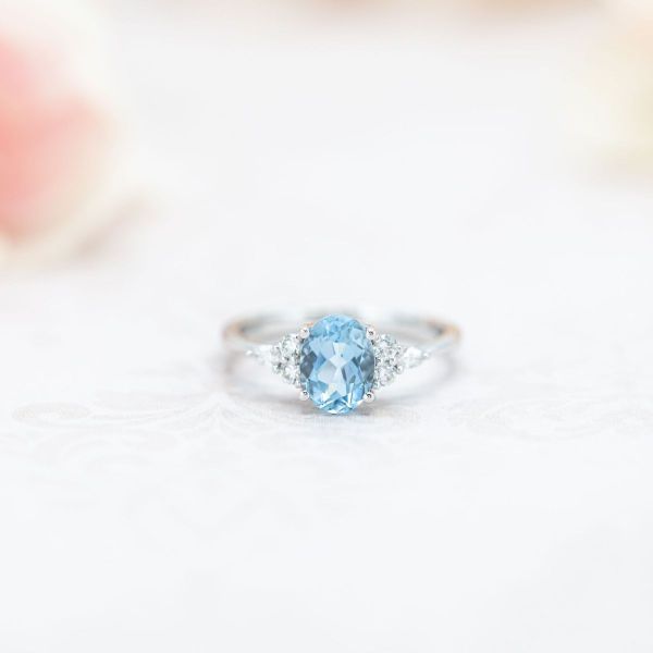 This ring features an oval cut aquamarine in white gold with accent diamonds hugging each side.