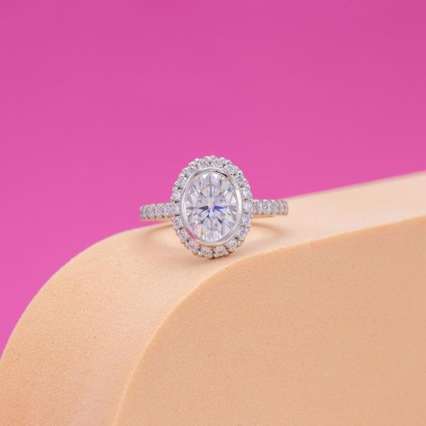 This oval moissanite sits in a halo setting.