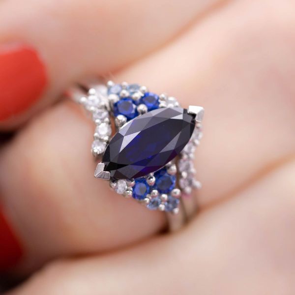 True blue! Why settle for one shade when you can have them all? Clusters of blue sapphires, aquamarine, and white sapphires sit on either side of a dark blue lab-created sapphire creating an ombre effect.