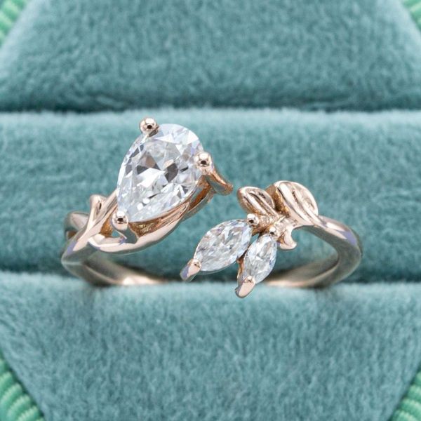 In this ring inspired by the colors and sights of autumn, the rose gold band holds a few moissanite stones positioned to look like leaves.