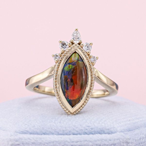 Opal and gold pair perfectly in this marquise cut center stone engagement ring.