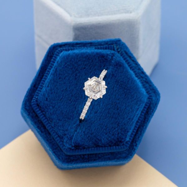 The hexagonal center moissanite is paired with moissanite accents.